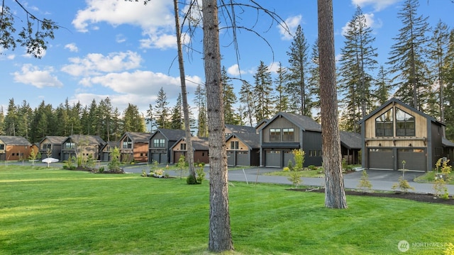 141 Panorama Dr, Cle Elum, WA 98922 - view of front facade with a garage, a residential view, driveway, and a front lawn