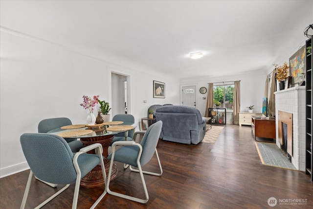 220 W Willis St, Kent, WA 98032 - dining room with a fireplace and dark wood-style floors