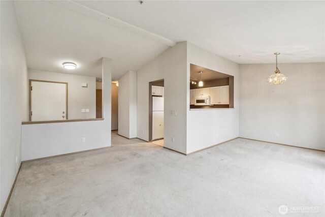 15150 140th Way SE Unit T304, Renton, WA 98058 - unfurnished room featuring light colored carpet, baseboards, and vaulted ceiling