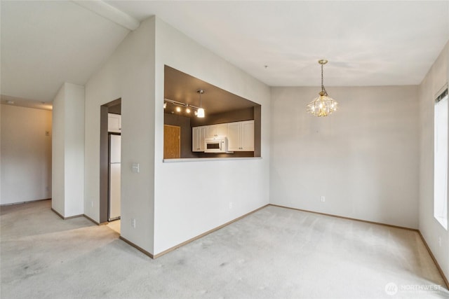 15150 140th Way SE Unit T304, Renton, WA 98058 - empty room with light carpet, a chandelier, and baseboards