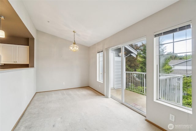 15150 140th Way SE Unit T304, Renton, WA 98058 - empty room with light colored carpet, a chandelier, baseboards, and lofted ceiling