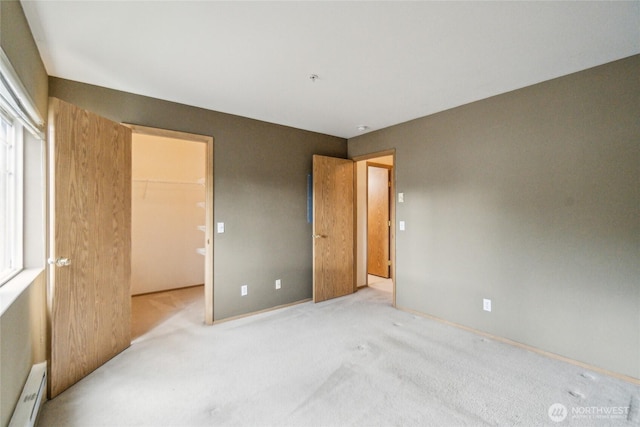 15150 140th Way SE Unit T304, Renton, WA 98058 - unfurnished bedroom with baseboard heating, a closet, carpet flooring, a walk in closet, and baseboards