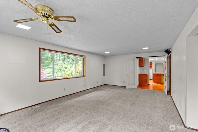 4205 Delphi Rd SW, Olympia, WA 98512 - unfurnished living room with light carpet, a textured ceiling, ceiling fan, electric panel, and baseboards