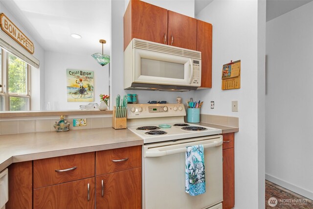 20800 72nd Ave W Unit 202, Edmonds, WA 98026 - kitchen featuring white appliances, brown cabinets, light countertops, and recessed lighting