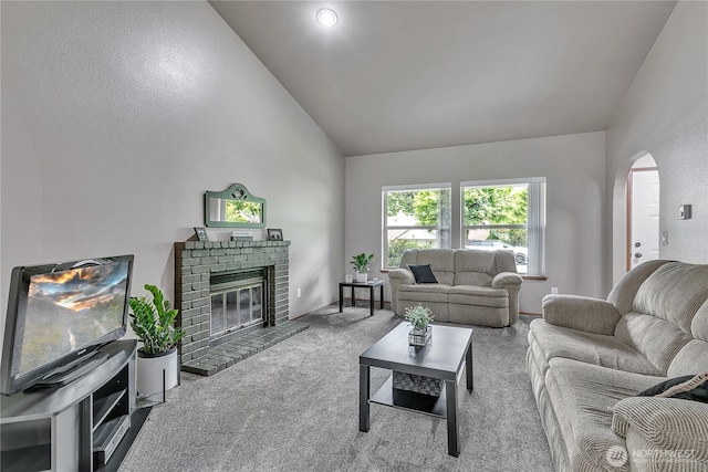 56065608 76th Street Ct E, Puyallup, WA 98371 - carpeted living room with arched walkways, a fireplace, and high vaulted ceiling