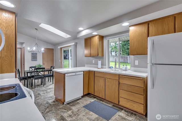 56065608 76th Street Ct E, Puyallup, WA 98371 - kitchen with white appliances, a sink, a skylight, a peninsula, and vaulted ceiling