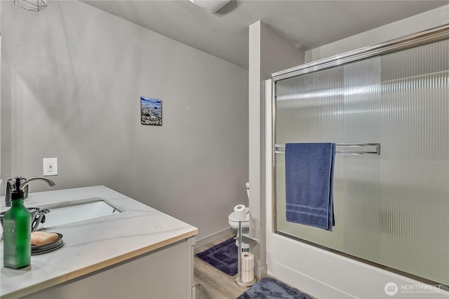 56065608 76th Street Ct E, Puyallup, WA 98371 - full bath featuring vanity, toilet, wood finished floors, and enclosed tub / shower combo
