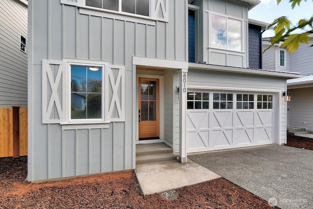 8010 222nd St SW, Edmonds, WA 98026 - property entrance featuring board and batten siding, a garage, and driveway