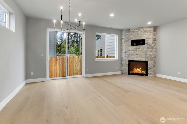 8010 222nd St SW, Edmonds, WA 98026 - unfurnished living room featuring light wood-style floors, a fireplace, a chandelier, baseboards, and recessed lighting