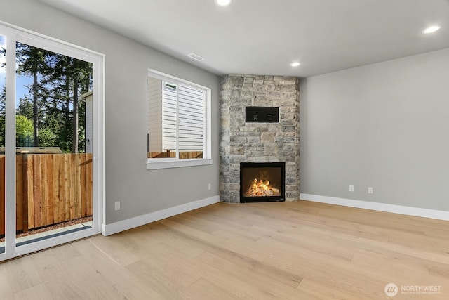 8010 222nd St SW, Edmonds, WA 98026 - unfurnished living room featuring wood finished floors, a stone fireplace, recessed lighting, and baseboards