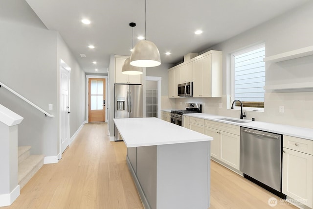 8010 222nd St SW, Edmonds, WA 98026 - kitchen featuring stainless steel appliances, a sink, a kitchen island, light wood-style floors, and recessed lighting
