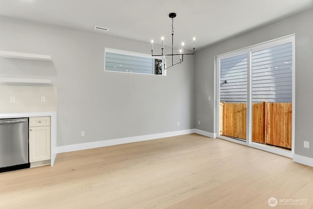 8010 222nd St SW, Edmonds, WA 98026 - unfurnished dining area featuring a chandelier, light wood finished floors, and baseboards