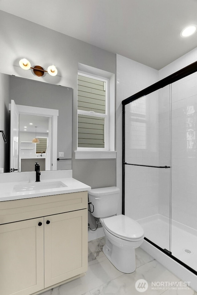 8010 222nd St SW, Edmonds, WA 98026 - bathroom featuring a stall shower, marble look tiles, toilet, vanity, and recessed lighting