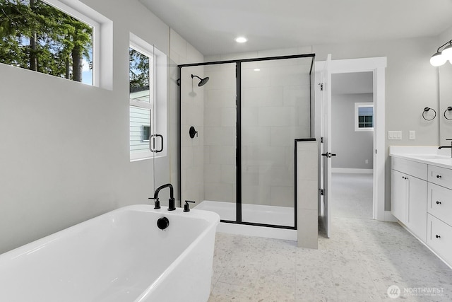 8010 222nd St SW, Edmonds, WA 98026 - bathroom featuring a stall shower, a soaking tub, vanity, and baseboards