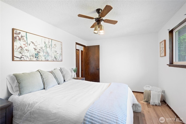 22412 110th Ave SE, Kent, WA 98031 - bedroom featuring wood finished floors, ceiling fan, a textured ceiling, and baseboards
