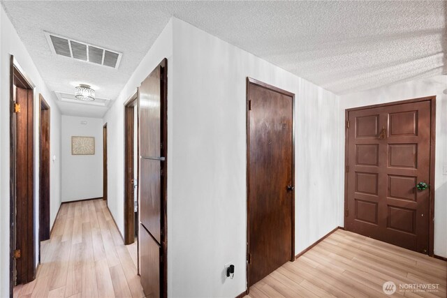 22412 110th Ave SE, Kent, WA 98031 - corridor featuring a textured ceiling and light wood-style flooring