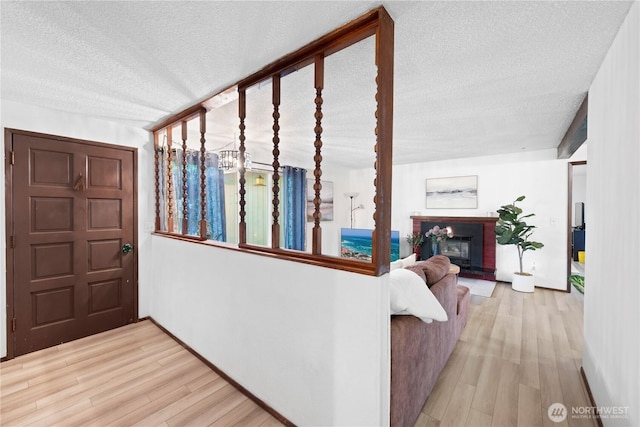 22412 110th Ave SE, Kent, WA 98031 - foyer with a textured ceiling, wood finished floors, a brick fireplace, and baseboards