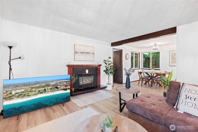 22412 110th Ave SE, Kent, WA 98031 - living area with wood finished floors, a textured ceiling, beamed ceiling, a brick fireplace, and a chandelier