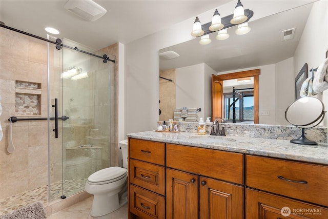 653 Lakayuse Rd, Manson, WA 98831 - bathroom featuring toilet, a stall shower, vanity, and tile patterned floors