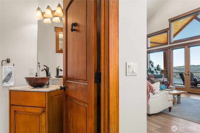 653 Lakayuse Rd, Manson, WA 98831 - bathroom with wood finished floors, vanity, and a chandelier