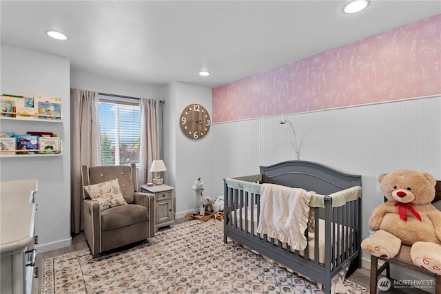 2562 Fancher Heights Blvd, East Wenatchee, WA 98802 - bedroom featuring wood finished floors, a nursery area, wainscoting, and recessed lighting