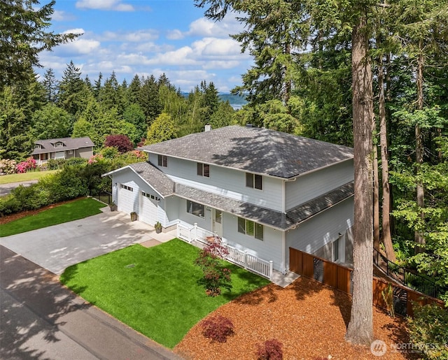 24390 Mount Washington View Ln NW, Poulsbo, WA 98370 - traditional-style house with covered porch, a shingled roof, an attached garage, a front yard, and driveway