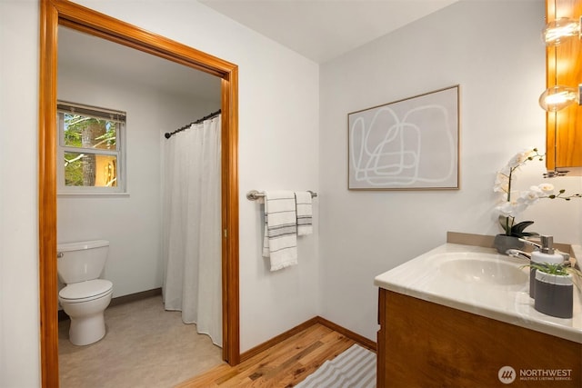 24390 Mount Washington View Ln NW, Poulsbo, WA 98370 - bathroom featuring vanity, toilet, baseboards, a shower with curtain, and wood finished floors