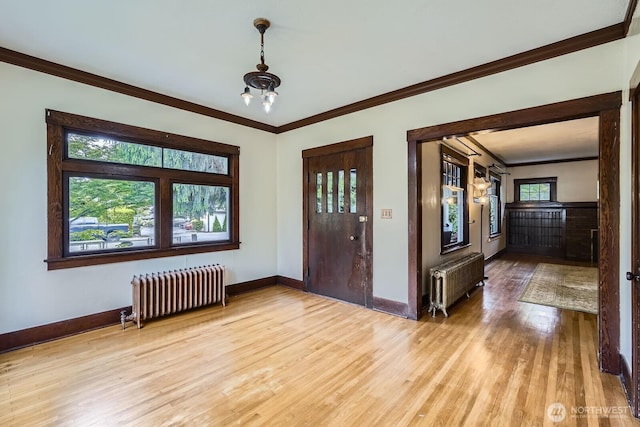 625 5th Ave S, Kent, WA 98032 - foyer featuring radiator heating unit, light wood finished floors, crown molding, and baseboards