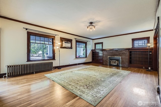 625 5th Ave S, Kent, WA 98032 - living room with radiator, wood finished floors, crown molding, baseboards, and a wall unit AC