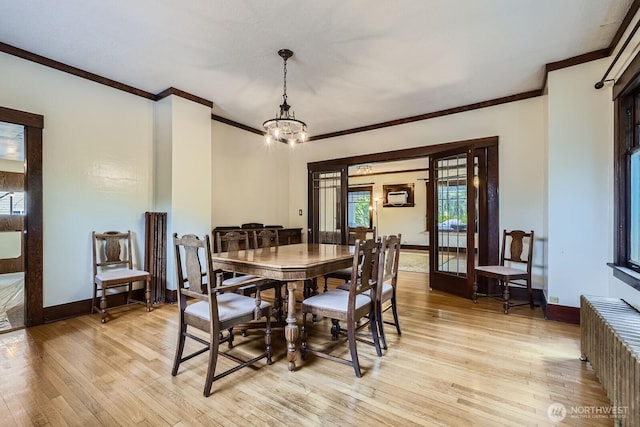 625 5th Ave S, Kent, WA 98032 - dining room featuring ornamental molding, light wood-style flooring, a chandelier, baseboards, and radiator