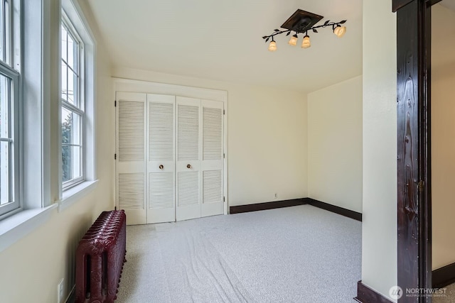 625 5th Ave S, Kent, WA 98032 - unfurnished bedroom featuring radiator, a closet, and baseboards