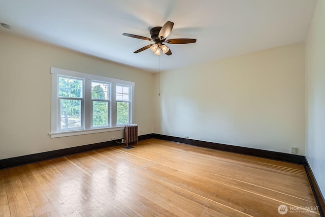 625 5th Ave S, Kent, WA 98032 - unfurnished room featuring radiator, ceiling fan, hardwood / wood-style flooring, and baseboards