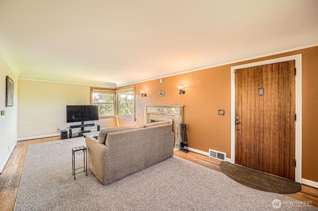 10758 22nd Ave SW, Seattle, WA 98146 - living room featuring ornamental molding, wood finished floors, a fireplace, and baseboards