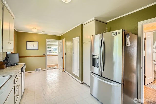 10758 22nd Ave SW, Seattle, WA 98146 - kitchen with stainless steel appliances, ornamental molding, light countertops, baseboards, and light floors