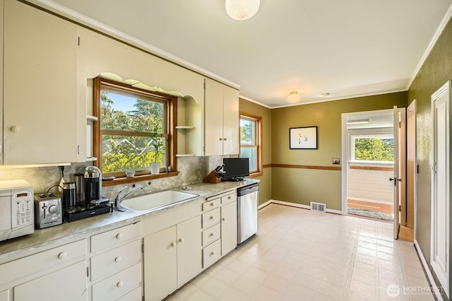 10758 22nd Ave SW, Seattle, WA 98146 - kitchen featuring a sink, dishwasher, white microwave, light countertops, and plenty of natural light