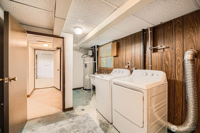 10758 22nd Ave SW, Seattle, WA 98146 - laundry room featuring water heater, washer and clothes dryer, and wood walls