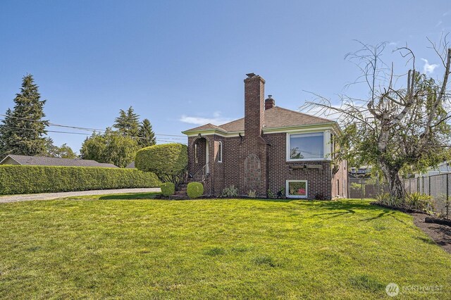 10758 22nd Ave SW, Seattle, WA 98146 - back of house featuring brick siding, a chimney, and a shingled roof