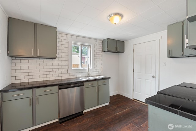325 NW 2nd Ave, Kelso, WA 98626 - kitchen featuring dishwasher, a sink, dark countertops, dark wood-type flooring, and decorative backsplash