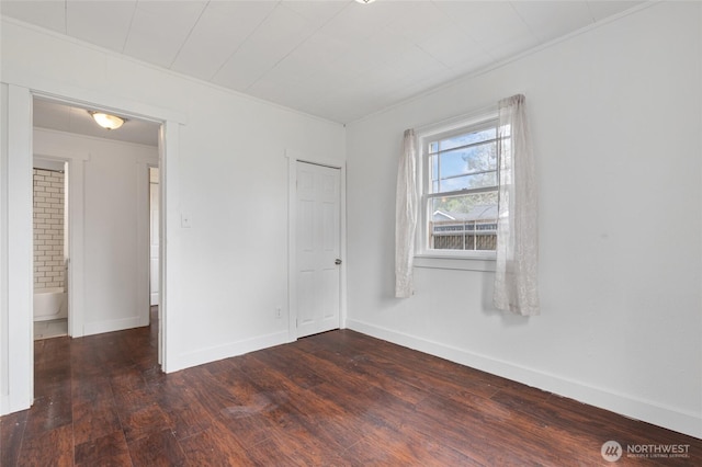325 NW 2nd Ave, Kelso, WA 98626 - unfurnished bedroom featuring dark wood-type flooring, baseboards, and crown molding