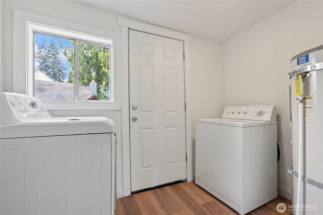 325 NW 2nd Ave, Kelso, WA 98626 - laundry area featuring washer and clothes dryer, light wood-style floors, and secured water heater