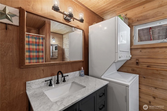 9460 Eagle Creek Rd, Leavenworth, WA 98826 - full bathroom featuring stacked washing machine and dryer, vanity, wooden ceiling, and wooden walls