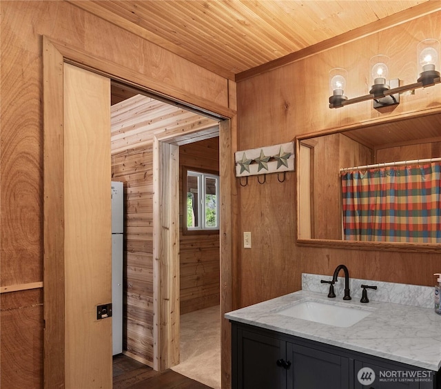 9460 Eagle Creek Rd, Leavenworth, WA 98826 - bathroom featuring vanity, wood walls, wooden ceiling, wood finished floors, and a shower with curtain