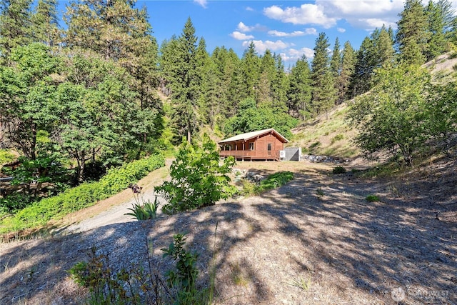 9460 Eagle Creek Rd, Leavenworth, WA 98826 - view of yard with a deck and a wooded view