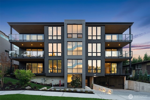 238 4th Ave Unit 101, Kirkland, WA 98033 - rear view of house featuring a balcony and driveway