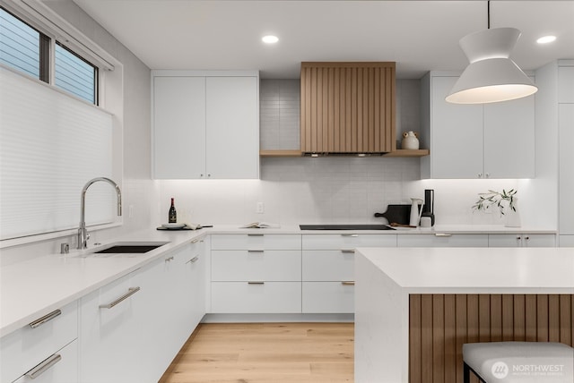 238 4th Ave Unit 101, Kirkland, WA 98033 - kitchen with modern cabinets, ventilation hood, backsplash, light countertops, and white cabinetry