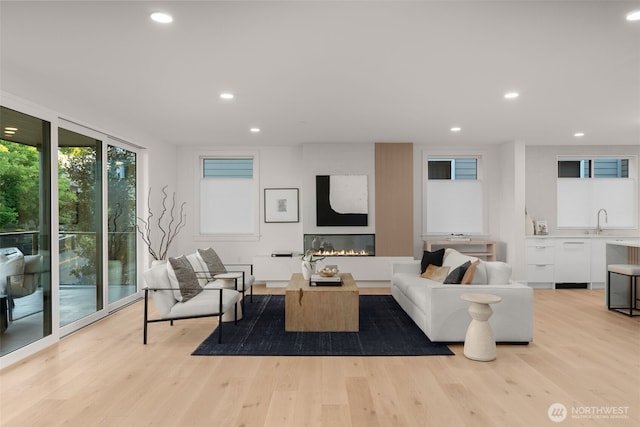 238 4th Ave Unit 101, Kirkland, WA 98033 - living room featuring recessed lighting, light wood finished floors, and a glass covered fireplace