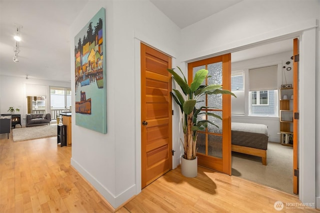 156 Hall Brothers Loop NE Unit 201, Bainbridge Island, WA 98110 - hallway featuring light wood finished floors and baseboards