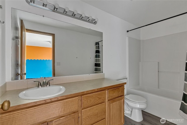 9201 S G St, Tacoma, WA 98444 - bathroom featuring toilet, washtub / shower combination, wood finished floors, and vanity