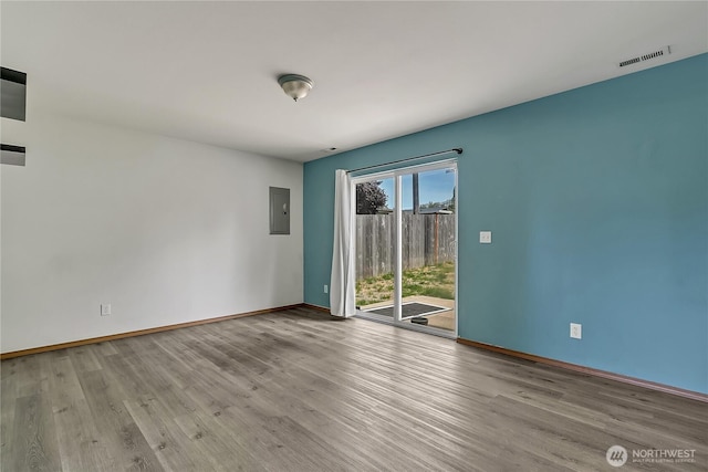 9201 S G St, Tacoma, WA 98444 - empty room featuring wood finished floors, baseboards, and electric panel