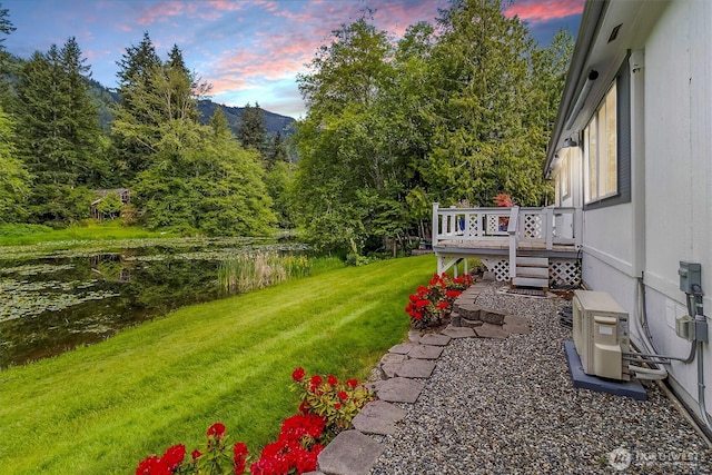 495 Lakeside Dr, Sedro Woolley, WA 98284 - yard at dusk featuring a yard, a deck with mountain view, and ac unit